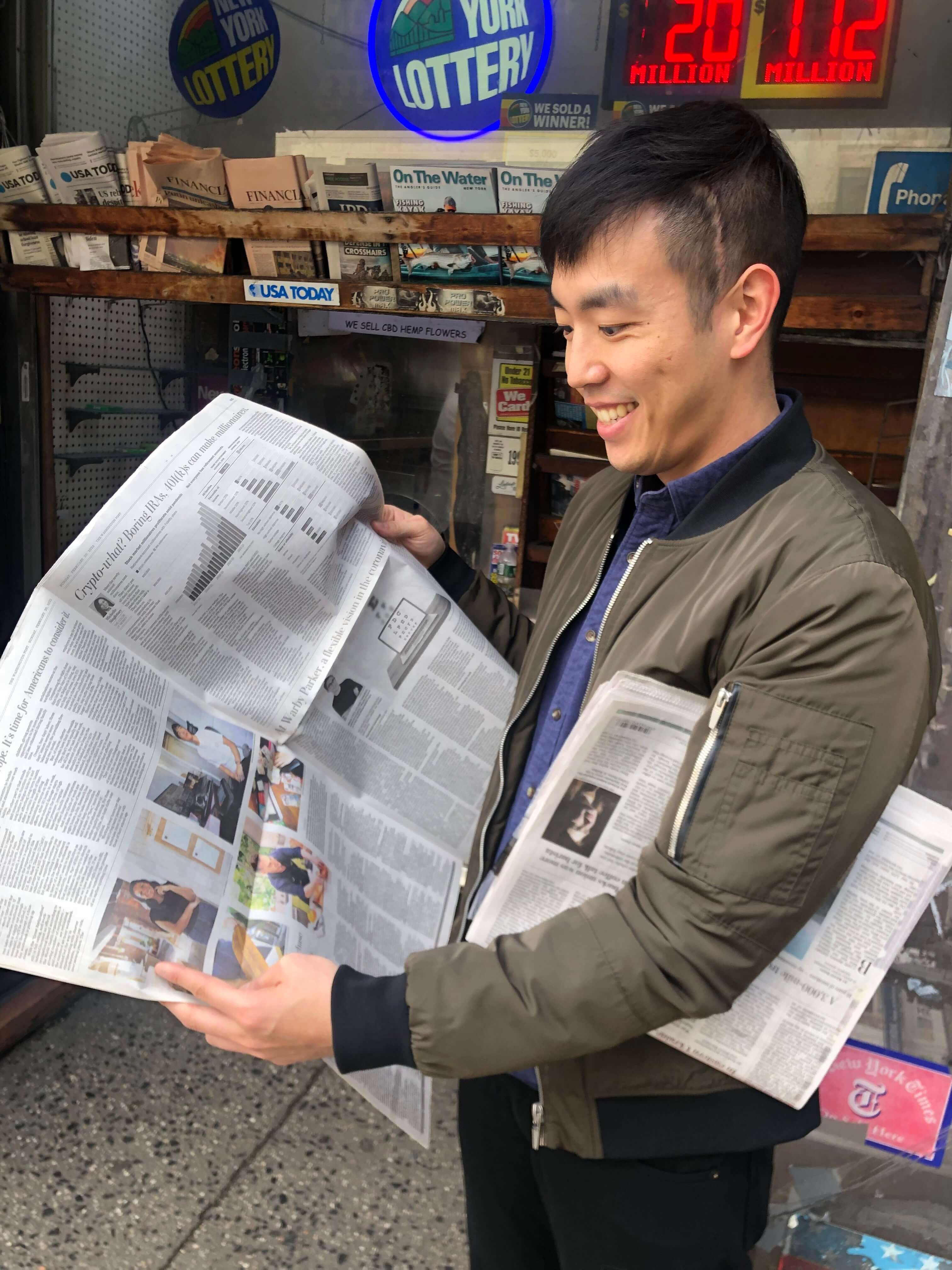 Me holding a newspaper with my face printed on it.